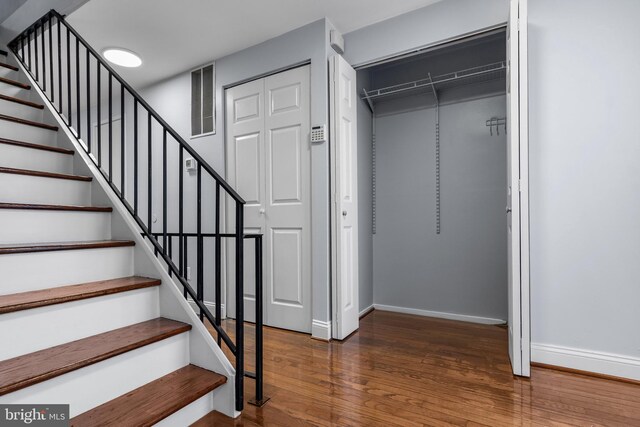 stairway featuring baseboards and wood finished floors
