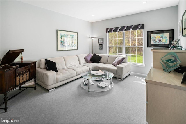 carpeted living area with recessed lighting and baseboards