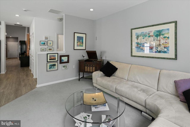 living area featuring recessed lighting, visible vents, carpet floors, and baseboards