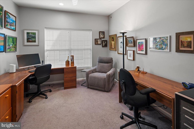 home office featuring light colored carpet and baseboards