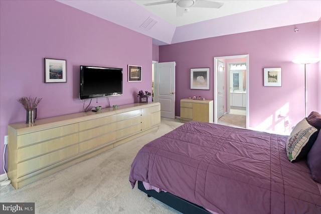 carpeted bedroom with visible vents and ensuite bath