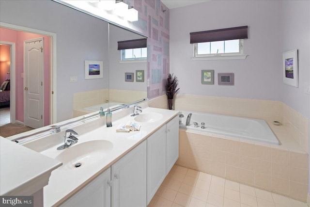 full bath with tile patterned floors, a garden tub, ensuite bath, and a sink