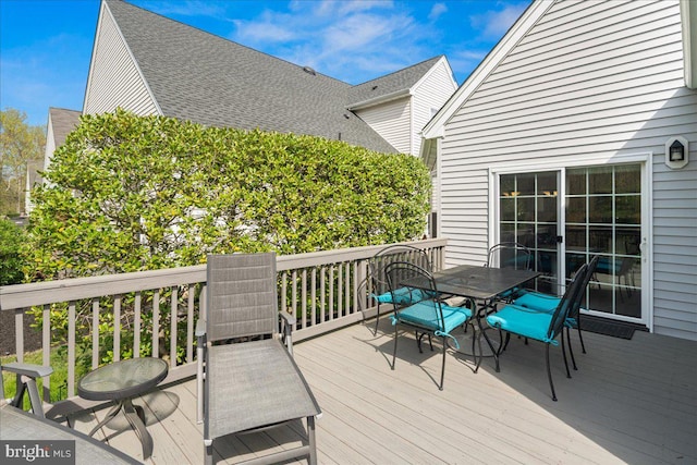 wooden deck with outdoor dining space