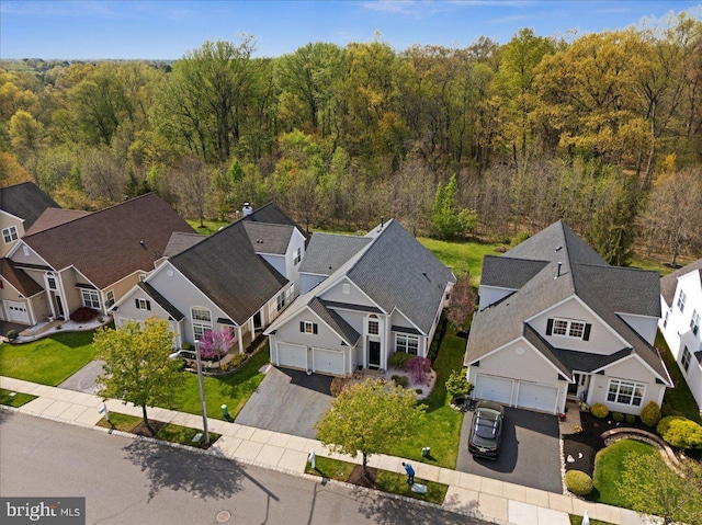 aerial view featuring a residential view and a wooded view
