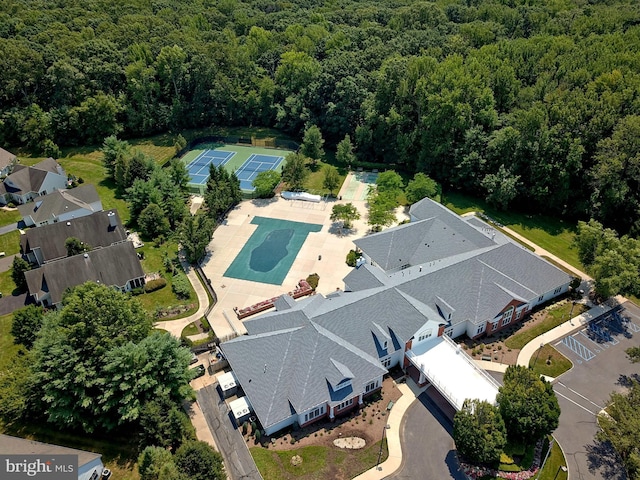 drone / aerial view with a wooded view
