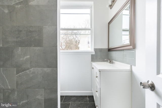 full bath with baseboards and vanity