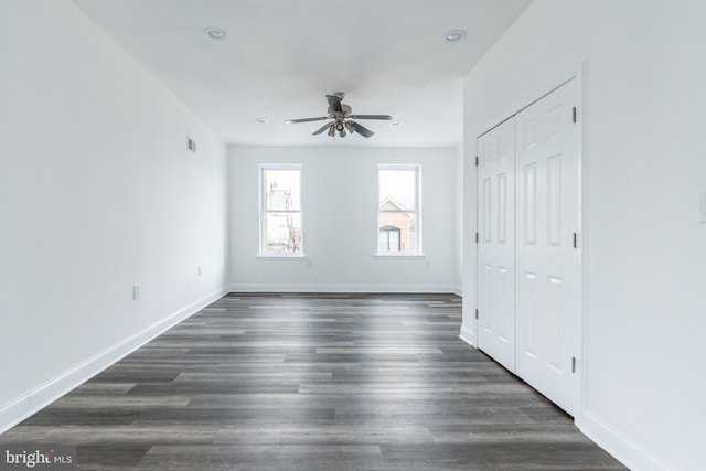 unfurnished bedroom featuring recessed lighting, dark wood finished floors, visible vents, a closet, and baseboards