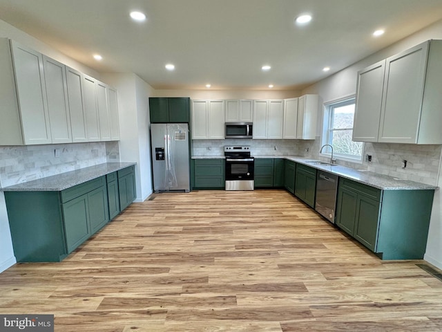 531 E High St, Bellefonte, PA 16823 - kitchen with backsplash, green cabinetry, stainless steel appliances, and a sink