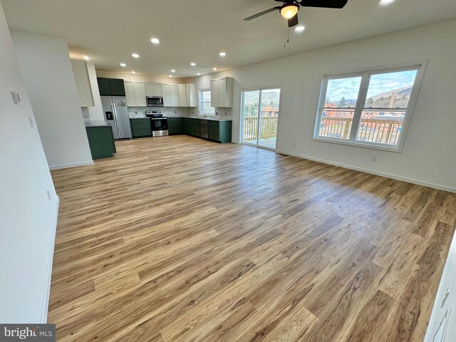 531 E High St, Bellefonte, PA 16823 - unfurnished living room with recessed lighting, a ceiling fan, a sink, light wood-type flooring, and baseboards