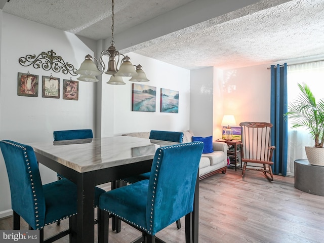8554 Koluder Ct, Lorton, VA 22079 - dining space with wood finished floors, a textured ceiling, and a chandelier