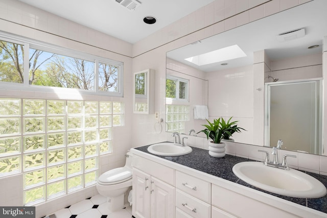 1004 Union Church Rd, Mclean, VA 22102 - full bathroom featuring a skylight, a shower stall, tile walls, and a sink