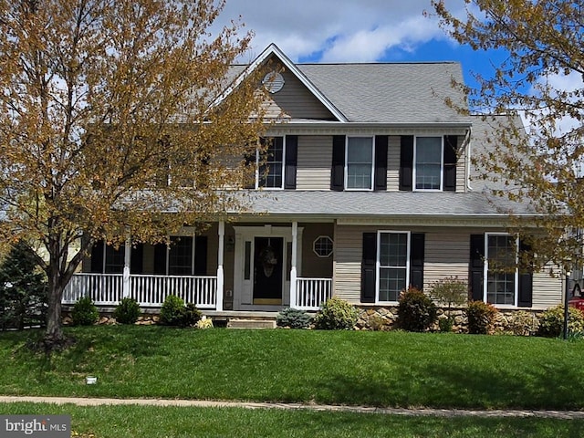 view of front of home with a porch, a front lawn, and a shingled roof