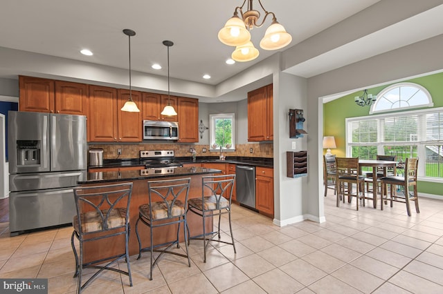kitchen featuring stainless steel appliances, a chandelier, light tile patterned floors, and recessed lighting