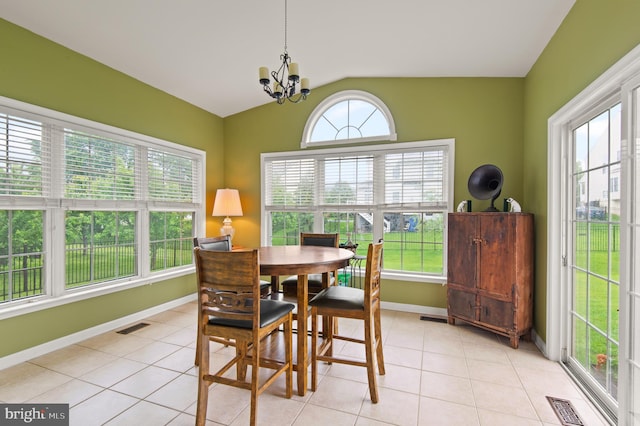 dining room with lofted ceiling, a chandelier, baseboards, and light tile patterned floors