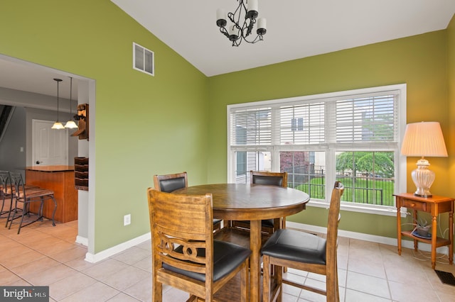 dining room featuring a chandelier, light tile patterned floors, baseboards, and high vaulted ceiling