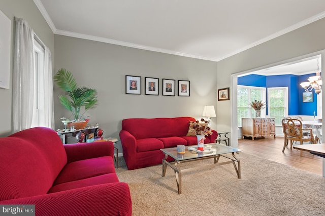 living room featuring crown molding, wood finished floors, and a chandelier