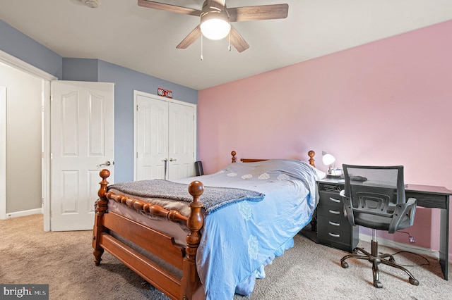 carpeted bedroom featuring a closet, ceiling fan, baseboards, and a desk