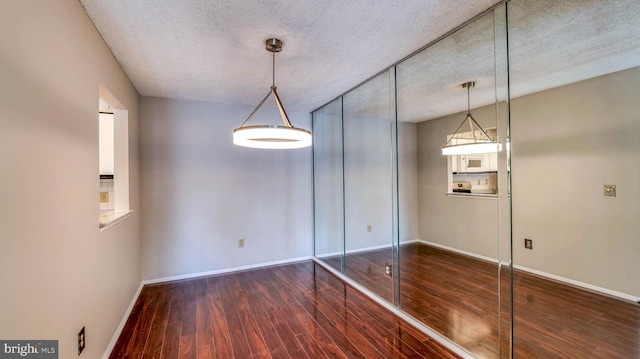 68 Arapaho Pl, Galloway, NJ 08205 - unfurnished dining area featuring wood finished floors, a textured ceiling, and baseboards