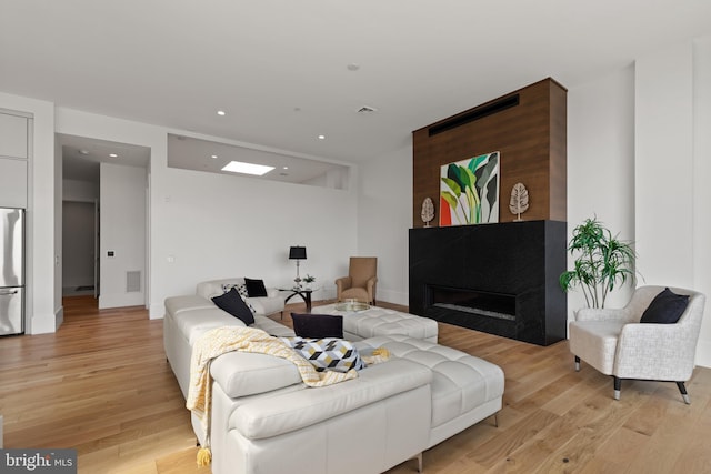 101 N Queen St Unit 402, Lancaster, PA 17603 - living room with recessed lighting, visible vents, light wood-style floors, baseboards, and a glass covered fireplace