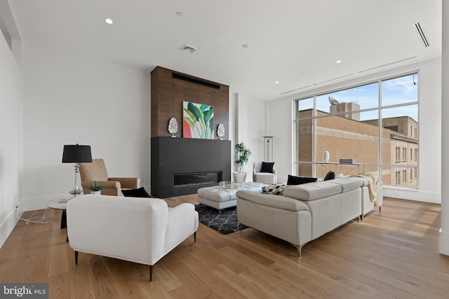 101 N Queen St Unit 402, Lancaster, PA 17603 - living room featuring a large fireplace, light wood-style floors, visible vents, and recessed lighting