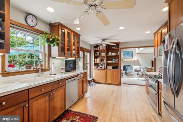9 Still Run Dr, Mickleton, NJ 08056 - kitchen featuring decorative backsplash, ceiling fan, brown cabinets, a sink, and stainless steel appliances