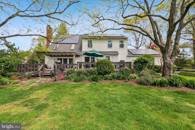 9 Still Run Dr, Mickleton, NJ 08056 - back of house featuring a lawn, a deck, solar panels, and a chimney