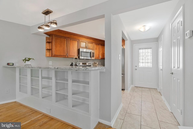 2102 Whisperwood Glen Ln, Reston, VA 20191 - kitchen with open shelves, appliances with stainless steel finishes, light stone counters, brown cabinetry, and baseboards