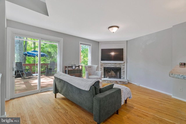 2102 Whisperwood Glen Ln, Reston, VA 20191 - living area featuring light wood-style floors, baseboards, and a stone fireplace