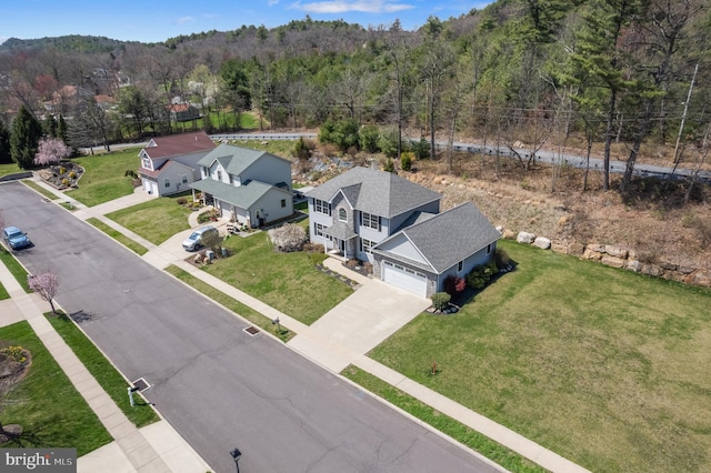 bird's eye view with a wooded view
