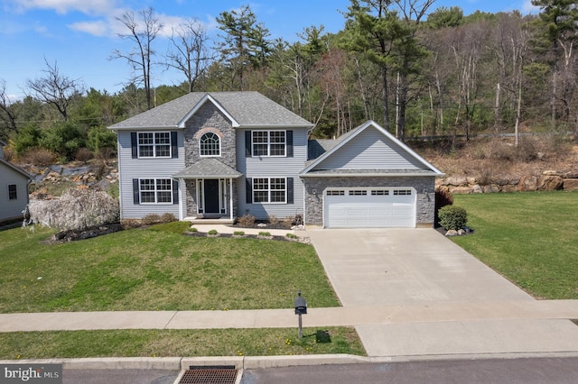 colonial house with concrete driveway, stone siding, an attached garage, a front yard, and roof with shingles