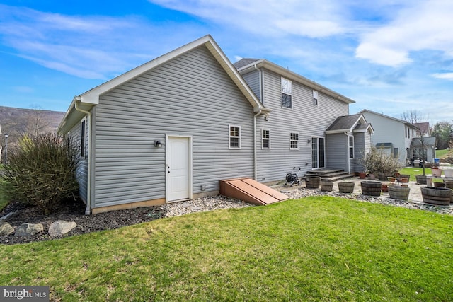 back of house with a lawn