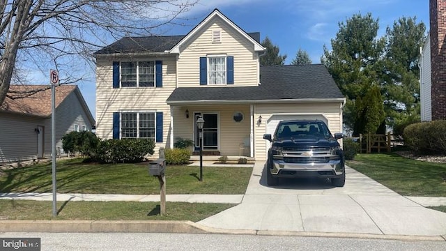 traditional-style house with a garage, a front lawn, and driveway