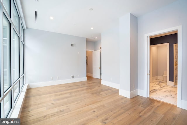 empty room with recessed lighting, visible vents, light wood-style floors, and baseboards