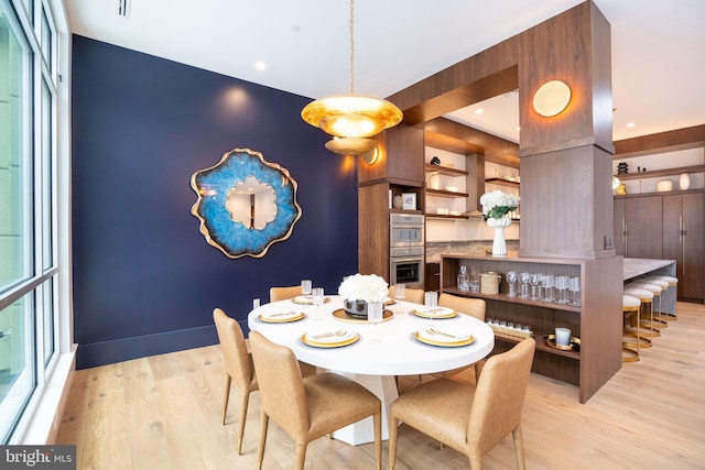 dining space with light wood-type flooring