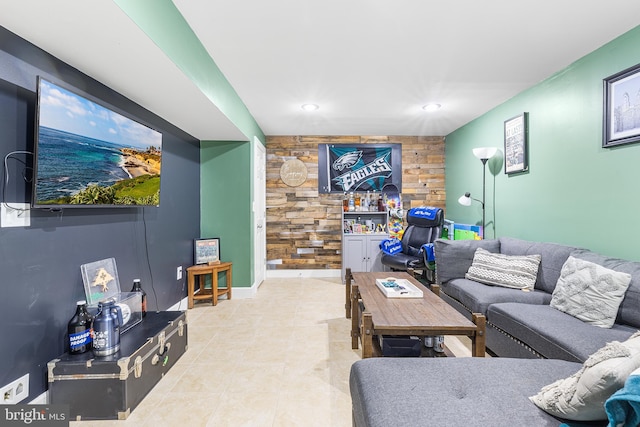 living area with recessed lighting, an accent wall, and light tile patterned floors