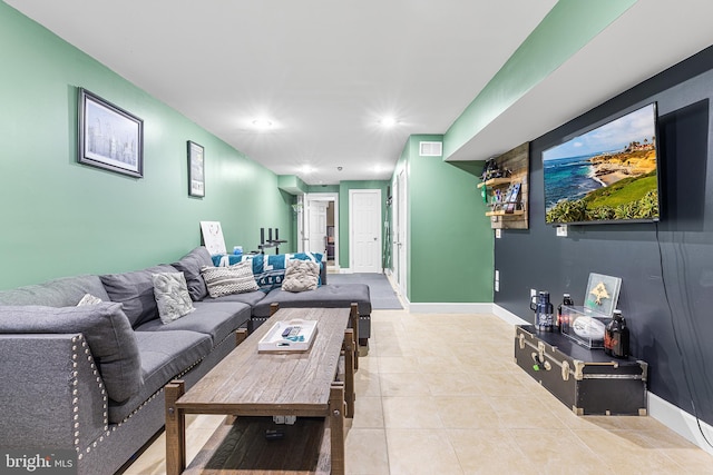 living room featuring visible vents, baseboards, recessed lighting, and light tile patterned floors