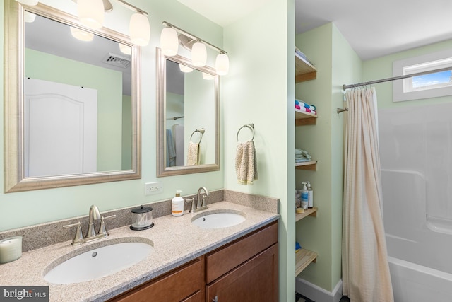 bathroom with shower / bath combo, visible vents, a sink, and double vanity