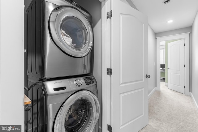 laundry room featuring baseboards, carpet, recessed lighting, stacked washer / drying machine, and laundry area