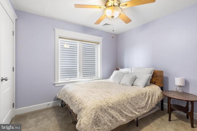 bedroom featuring baseboards, a ceiling fan, visible vents, and carpet