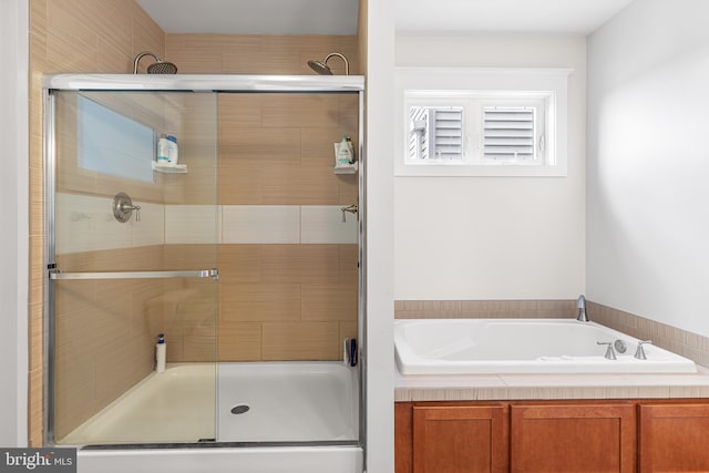 bathroom with a bath and a stall shower