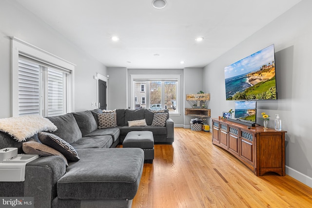 living area featuring baseboards, recessed lighting, and light wood-style floors