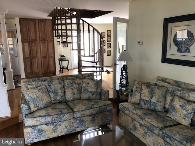 14121 Caine Stable Rd, Ocean City, MD 21842 - living room featuring stairway, ornate columns, and wood finished floors