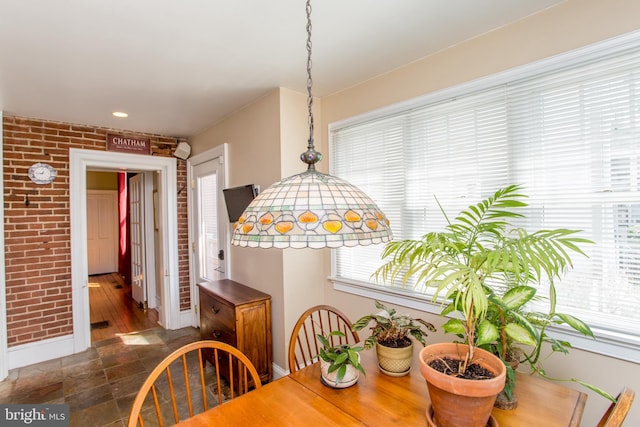 36 S Clinton St, Doylestown, PA 18901 - dining room featuring a healthy amount of sunlight, brick wall, and baseboards