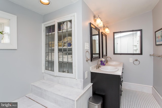 36 S Clinton St, Doylestown, PA 18901 - full bathroom with tile patterned floors, baseboards, double vanity, and a sink