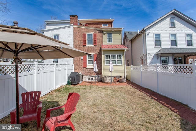 36 S Clinton St, Doylestown, PA 18901 - back of property featuring a lawn, a chimney, brick siding, and a fenced backyard