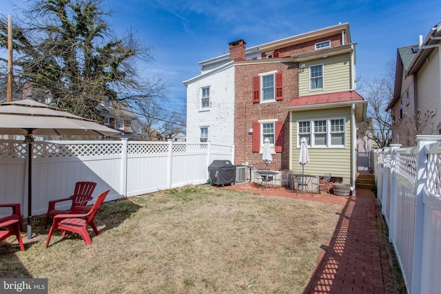 36 S Clinton St, Doylestown, PA 18901 - back of property with a chimney, a fenced backyard, a yard, brick siding, and a patio area