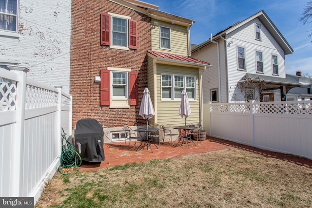 36 S Clinton St, Doylestown, PA 18901 - back of property featuring a standing seam roof, a fenced backyard, metal roof, and a lawn