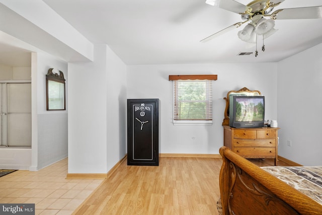 bedroom with baseboards, a ceiling fan, light wood-style flooring, and visible vents