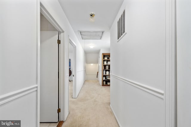 corridor with visible vents and light colored carpet