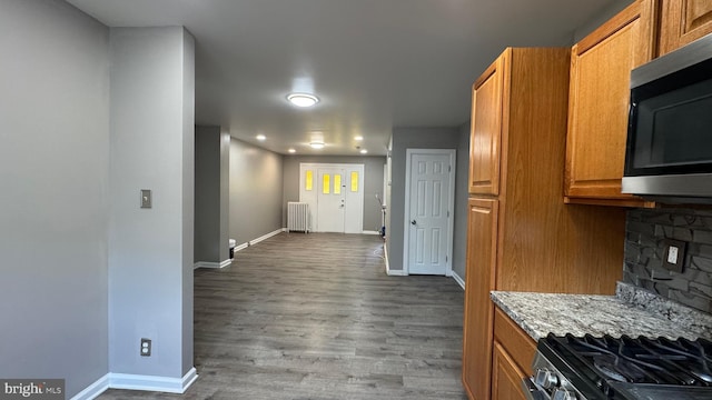 5915 Palmetto St, Philadelphia, PA 19120 - kitchen featuring radiator heating unit, appliances with stainless steel finishes, baseboards, and brown cabinets